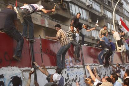 Cientos de egipcios martillean el muro que protege la Embajada de Israel en El Cairo.
