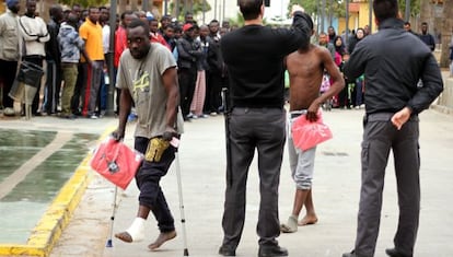 Two of the immigrants who jumped the fence arrive at the CETI temporary immigrant holding center in Melilla.