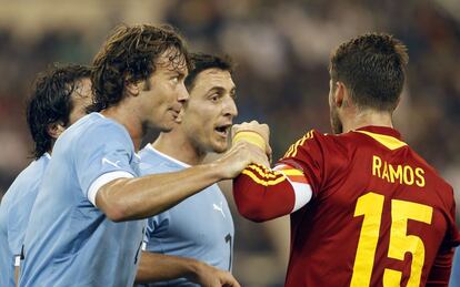 Ramos discute con los jugadores uruguayos Diego Lugano (izquierda) y and Cristian Rodríguez (en el centro) durante el encuentro amistoso contra Uruguay disputado en Doha el 6 de febrero de 2013 (fue el partido 99 del sevillano). España venció a los uruguayos el 6 de febrero por 3-1.
