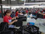 This photo taken on July 15, 2020 shows workers producing bags that will be exported at a textile factory in Huaibei in China's eastern Anhui province. - China's economy returned to growth in the second quarter, rebounding more strongly than expected from a historic contraction caused by the coronavirus outbreak, official data showed on July 16. (Photo by STR / AFP) / China OUT