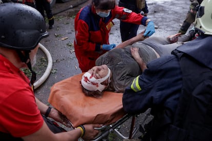 Una herida es atendida tras ser liberada de los escombros de un edificio atacado por un dron ruso en Járkov, este sábado.