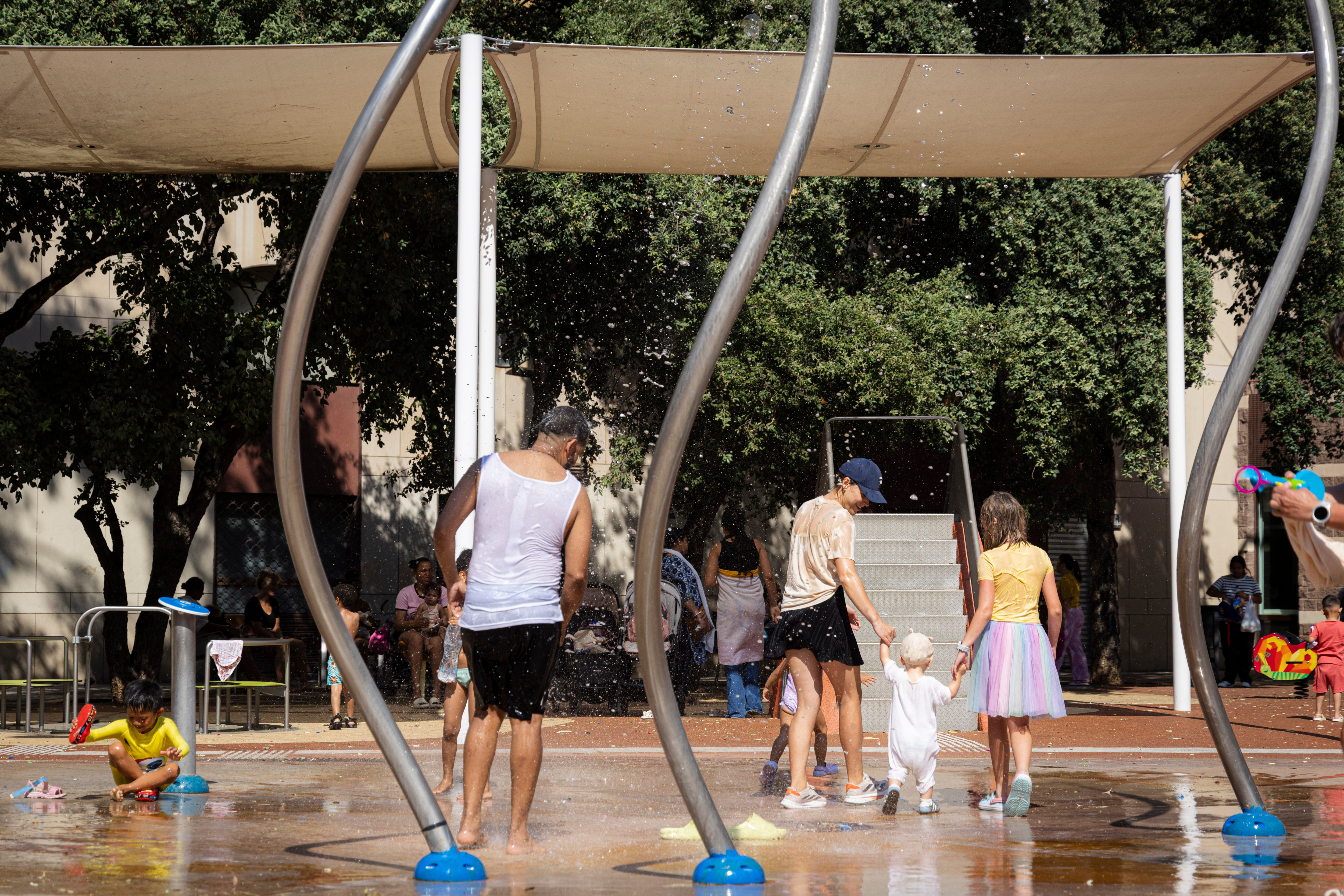 Vecinos del Raval de Barcelona refrescándose en una fuente.