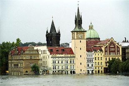 La torre Novotneho Lavka y algunos restaurantes, inundados ayer cerca del puente de Carlos IV, en el centro de Praga.