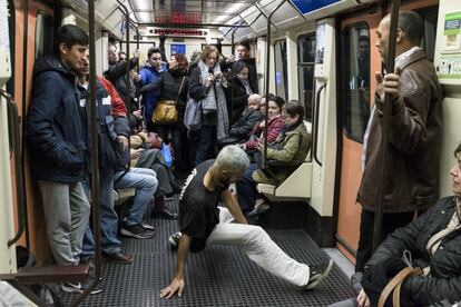 Una persona baila en un coche del metro de Madrid.