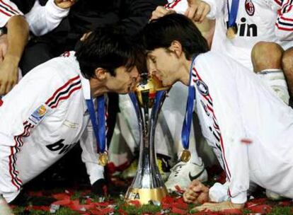 Kaká e Inzaghi besan el trofeo del Mundial de clubes ganado ayer.