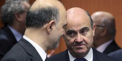 El ministro de Economía, Luis de Guindos, conversa con el comisario europeo de Asuntos Económicos y Financieros, Pierre Moscovici.