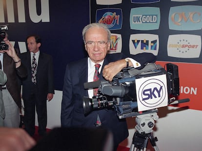 Media tycoon Rupert Murdoch poses with a Sky television camera during the launch of his multi-channel package in central London on Wednesday, Sept. 1, 1993.