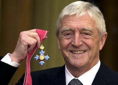 Chat show host Michael Parkinson poses for pictures after he was awarded the Most excellent order of the British Empire (MBE) at Buckingham Palace November 24, 2000.
