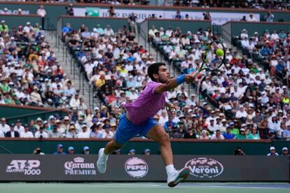 El tenista español Carlos Alcaraz devuelve la pelota al ruso Daniil Medvedev.