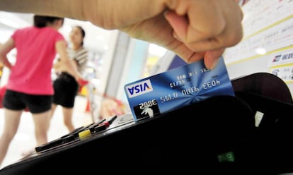 Un hombre utiliza una tarjeta de crédito de Visa.