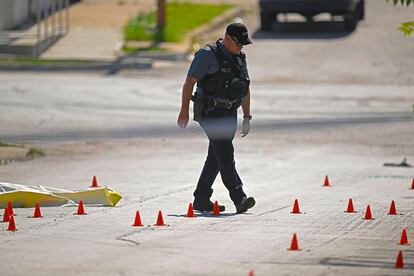 Evidence markers filled the street as police were investigating the scene after several people died and others were injured following a shooting early Sunday, June 25, 2023.