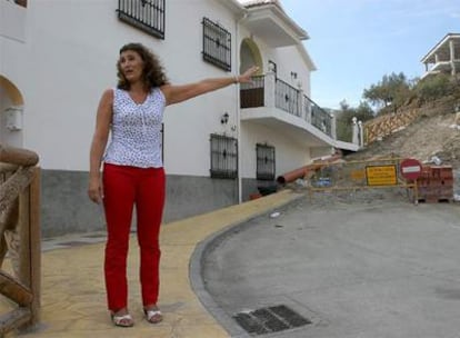 La alcaldesa de Árchez, Amalia Jiménez, señala una obra de un carril nuevo en el pueblo.