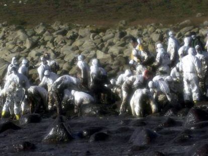 Voluntarios limpian chapapote del &#039;Prestige&#039; en los alrededores del cabo Touri&ntilde;&aacute;n (A Coru&ntilde;a).