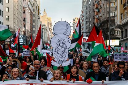 Protesters in Madrid hold a drawing of Handala, the iconic character of a refugee child by Palestinian artist Naji al Ali, on January 27 in Madrid.