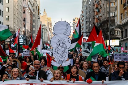 Protesters in Madrid hold a drawing of Handala, the iconic character of a refugee child by Palestinian artist Naji al Ali, on January 27 in Madrid.