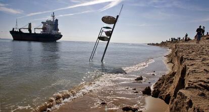 La silla del socorrista se hunde en el mar ante una suerte de acantilado provocado por las hélices de uno de los cargueros varados en El Saler.