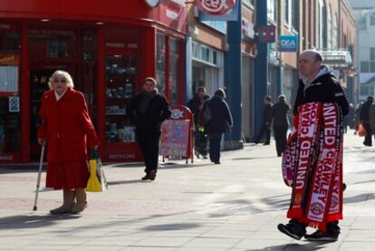 Un hombre vende bufandas del equipo de la ciudad en Crawley.