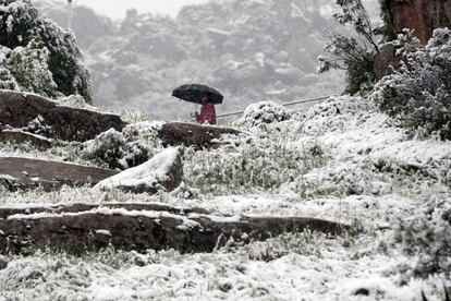 Un hombre camina entre la nieve en Manzanares el Real, Madrid. Antes las predicciones de la Agencia Estatal de Meteorología (AEMET), ha avisado a la Sierra de Madrid por nevadas a partir de 800 metros a 1.000 metros, que subirá a partir del martes hasta los 1.400 metros de altura y tenderán a disminuir.