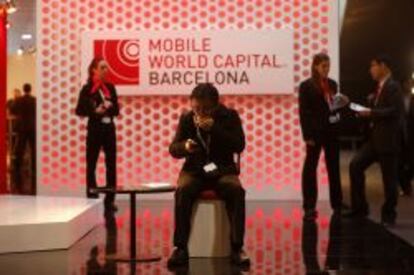 Un visitante del Mobile World Congress escribe un mensaje con su smartphone.