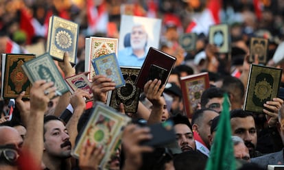 Iraqi demonstrators carry copies of the Koran and chant slogans during a protest near the Green Zone in Baghdad, Iraq, 22 July 2023