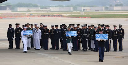 Guarda de honra dos EUA transporta os ataúdes com os restos procedentes da Coreia do Norte.