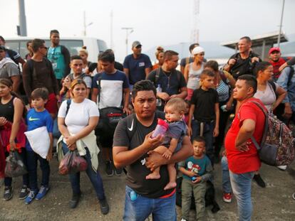 A group of Cuban migrants stand beside a road in Huixtla, a municipality in the South of Mexico, after their buses were stopped by the authorities.