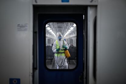 Un trabajador desinfecta un tren en la estación de Constitución, en Buenos Aires.