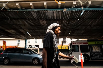 Sharday Miller, walks away holding extra bandages she received after having her skin treated at the Kensington Hospital wound care outreach van parked in the Kensington neighborhood of Philadelphia