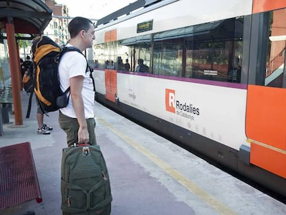 Unos usuarios esperan un tren de Rodalies.