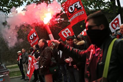 A man holds a flair during a protest against the proposed changes to France's working week and layoff practices, in Paris, Thursday, April 28, 2016. Protesters across France are again marching to voice their anger at labor reforms being championed by the country's Socialist government. (AP Photo/Thibault Camus)