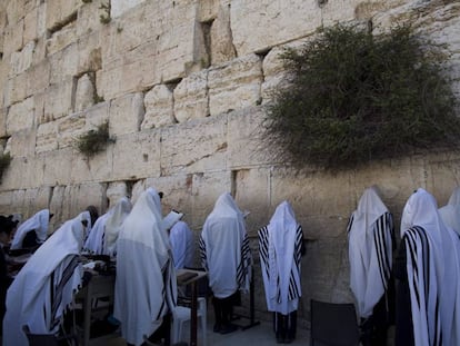 Jud&iacute;os ultra ortodoxos cubiertos con el manto de la oraci&oacute;n ante El Muro de las Lamentaciones de Jerusal&eacute;n. 