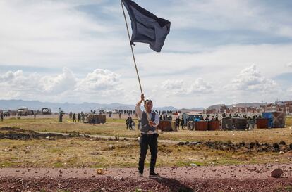 Un hombre ondea una bandera negra durante una protesta por la violencia policial contra los opositores al gobierno de Dina Boluarte, en Juliaca, el 11 de enero de 2023.