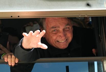 Brazil's former President Jair Bolsonaro waves to supporters at the Liberal Party's headquarters in Brasilia, Brazil, Thursday, March 30, 2023.