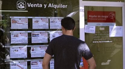 Vista de l'aparador d'una immobiliària a Madrid, amb anuncis de pisos en venda.