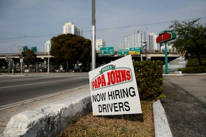 A "Now Hiring" sign advertising jobs at Papa Johns is seen along a street, as the spread of the coronavirus disease (COVID-19) continues, in downtown Miami, Florida, U.S. April 13, 2020.