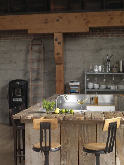 La barra de la cocina construida con tablones del suelo del salón.