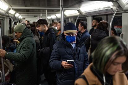 Usuarios del metro con y sin mascarillas en el suburbano de Barcelona.
