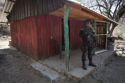 Un policía delante de la chabola en la que se refugió el narco.