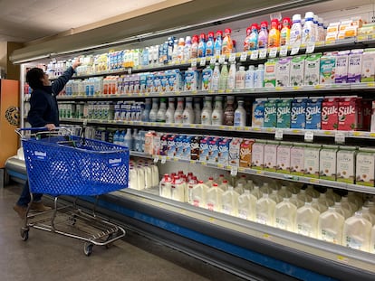 A customer shops for milk at a grocery store on December 12, 2023 in San Anselmo, California.