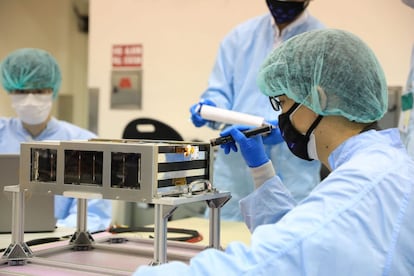 Members of the EQUULEUS (EQUilibriUm Lunar-Earth point 6U Spacecraft) team, preparing their CubeSat for launch on the Artemis I mission.