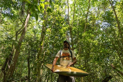 Roqui Bello shows a leaf from a tree in the wetland, on April 14.