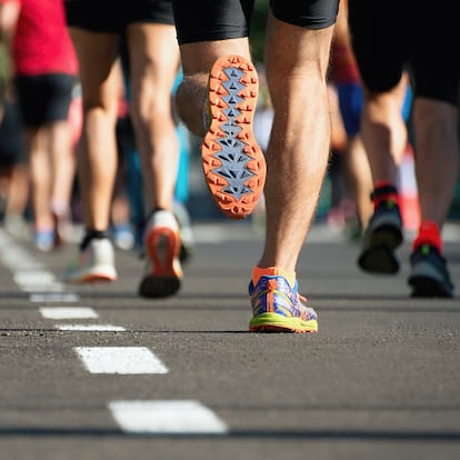 Marathon running race, people feet on city road