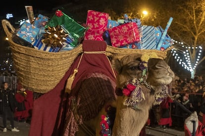 A camel carries two baskets filled with presents during the parade in Madrid.