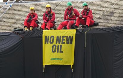 Greenpeace activists sit on the roof of Britain's Prime Minister Rishi Sunak's house in Richmond, North Yorkshire, England