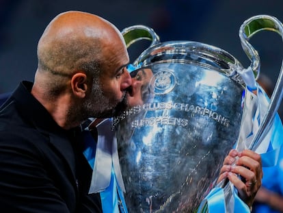 Manchester City's head coach Pep Guardiola kisses the trophy after winning the Champions League final soccer match at the Ataturk Olympic Stadium in Istanbul, Turkey, on June 11, 2023.