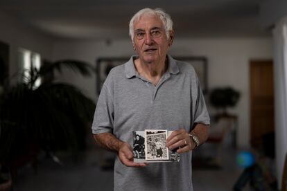 Pepito, son of Ana Garbín Alonso, holds two photographs of his mother. One of them shows him as a child.