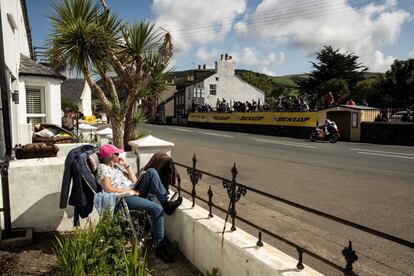Una mujer observa a los pilotos pasar durante la carrera del Classic TT, en la Isla de Man (Reino Unido), el 25 de agosto.