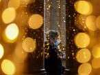 A woman wearing a protective mask is seen through a glass at a shopping centre on the day Italian Health Minister Roberto Speranza lays out in parliament the government's plan for mass coronavirus disease (COVID-19) vaccinations and restrictions over the Christmas period, in Rome, Italy December 2, 2020. REUTERS/Yara Nardi