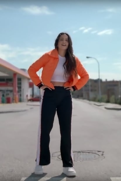 Chupa naranja de la firma española Kling y pantalones chandaleros con raya lateral de Juicy Couture son las prendas de este look. El videoclip tiene más de 750.000 reproducciones en Youtube en menos de 48 horas.