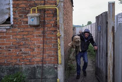 A resident flees Vovchansk after a Russian bombing, on May 14.